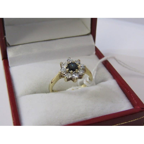 215 - 9ct GOLD CLUSTER RING, 9ct yellow gold ring set a blue stone to centre with clear stones to the oute... 