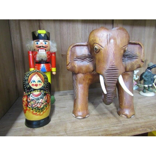 29 - TREEN, carved elephant stool, graduated wooden doll set and German nut cracker