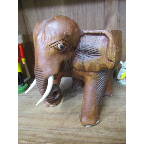 29 - TREEN, carved elephant stool, graduated wooden doll set and German nut cracker