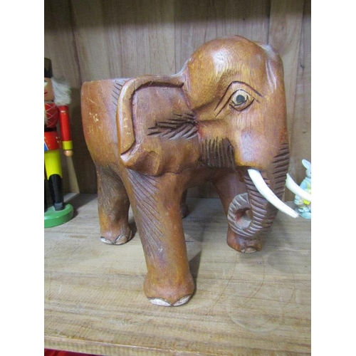 29 - TREEN, carved elephant stool, graduated wooden doll set and German nut cracker