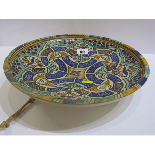 89 - ISLAMIC POTTERY, a shallow circular dish, 28cm diameter