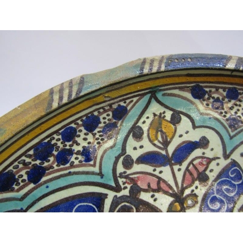 89 - ISLAMIC POTTERY, a shallow circular dish, 28cm diameter