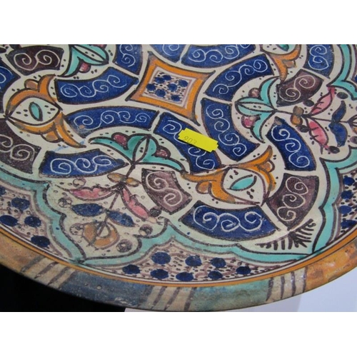 89 - ISLAMIC POTTERY, a shallow circular dish, 28cm diameter