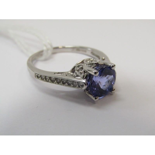 14 - TANZANITE & DIAMOND RING, 18ct white gold ring set a large oval tanzanite with 8mm spread, with diam... 