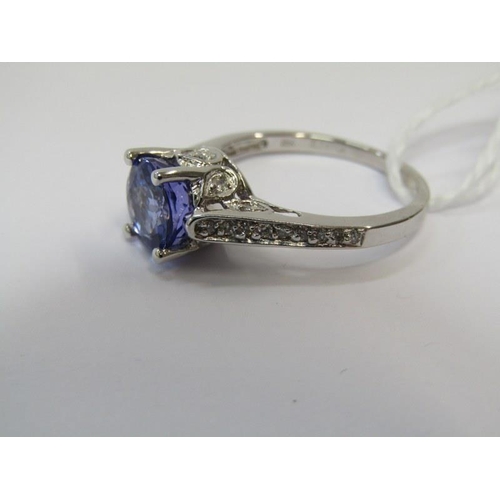 14 - TANZANITE & DIAMOND RING, 18ct white gold ring set a large oval tanzanite with 8mm spread, with diam... 