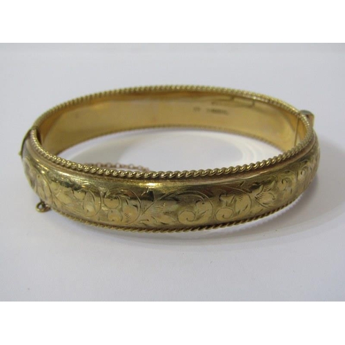 43 - GOLD BANGLE, 9ct yellow gold hinged bangle with foliate engraved decoration, 20.1 grams