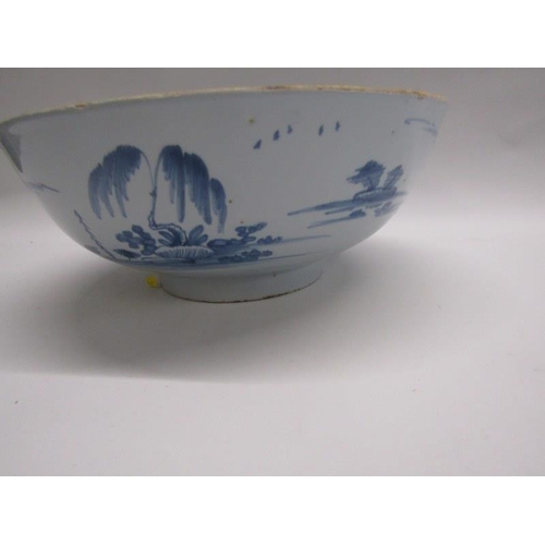 113 - ANTIQUE DELFT, chinoiserie design 27cm diameter deep centre bowl, decorated with figures in fenced g... 