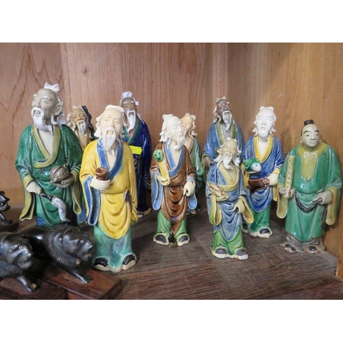 73 - ORIENTAL CERAMICS, collection of 10 pottery figures, together with 8 carved horn lions