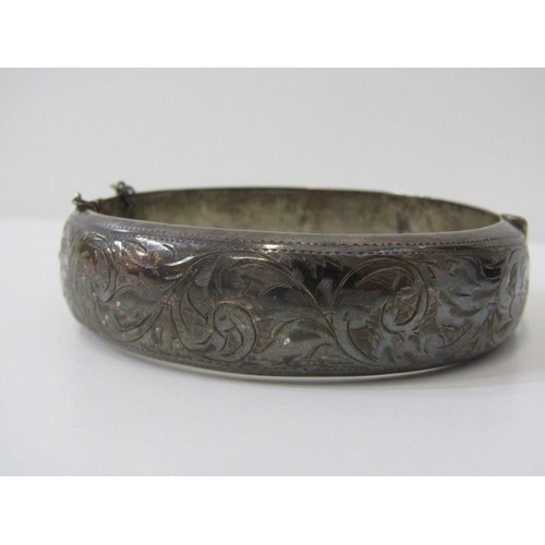 133 - SILVER JEWELLERY, a hinged silver bangle with foliate decoration, foliate decorated silver vesta cas... 