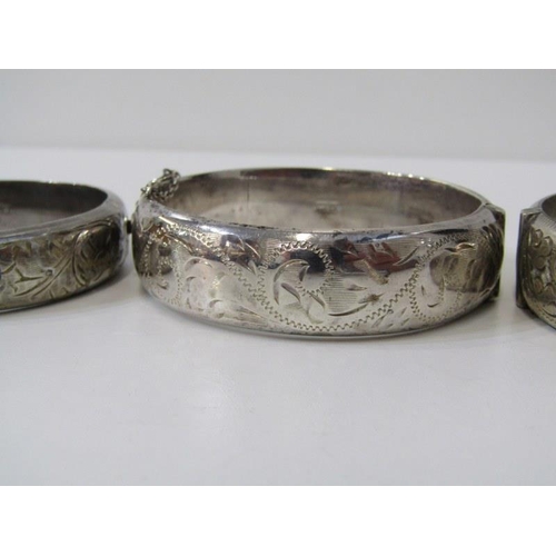 150 - SILVER BANGLES, 3 silver hinged bangles with foliate decoration