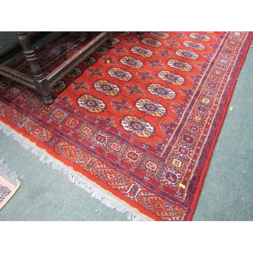 863 - EASTERN RUG, decorated multi medallions on a red ground, within multiple borders, 198cm length