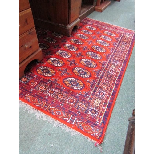 864 - MIDDLE EASTERN CARPET, Middle Eastern hand knotted rug, decorated multiple medallions on a red groun... 