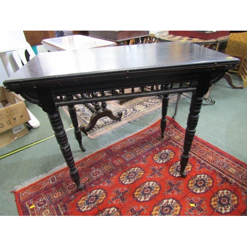 866 - EDWARDIAN CARD TABLE, ebonised folding card table, on turned supports and castor feet, 90cm width