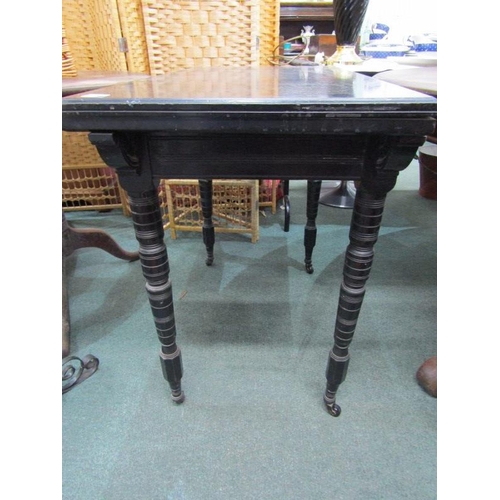 866 - EDWARDIAN CARD TABLE, ebonised folding card table, on turned supports and castor feet, 90cm width