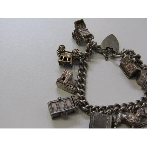 402 - SILVER CHARM BRACELET, curb link bracelet with padlock clasp with approximately 10 charms, 64.5grms