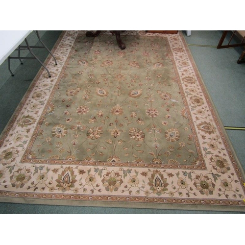 989 - CHINESE DESIGN CARPET, A floral decorated carpet on a green ground within 3 main borders, 3.4 m x 2.... 