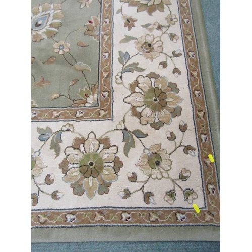 989 - CHINESE DESIGN CARPET, A floral decorated carpet on a green ground within 3 main borders, 3.4 m x 2.... 