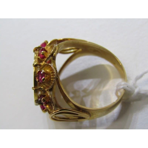 19 - COIN STYLE RING, 9ct yellow gold ring, set a coin style plaque with rubies to the outer, size K. 6.7... 