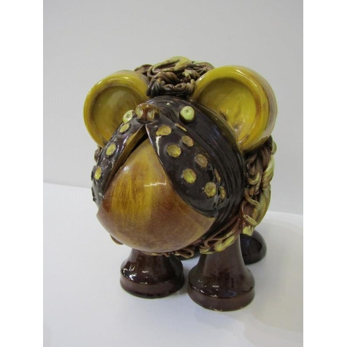 380 - STUDIO POTTERY, a comical slip glazed figure of lion, 19cm height