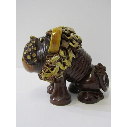 380 - STUDIO POTTERY, a comical slip glazed figure of lion, 19cm height