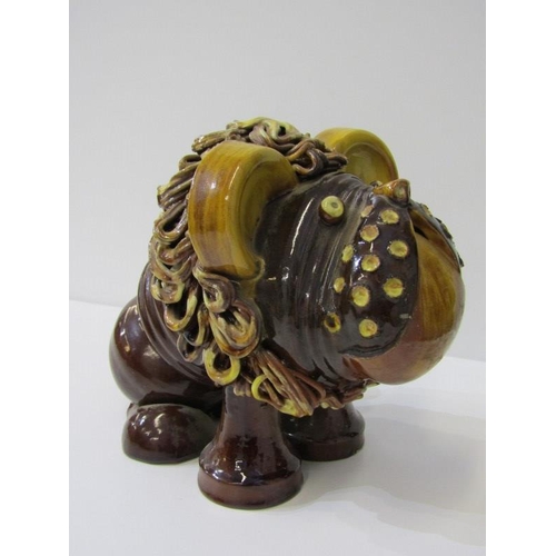 380 - STUDIO POTTERY, a comical slip glazed figure of lion, 19cm height