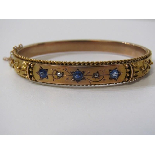 64 - SAPPHIRE, DIAMOND & GOLD BANGLE, 9ct yellow gold hinged bangle, set 3 cornflower sapphires, interspe... 