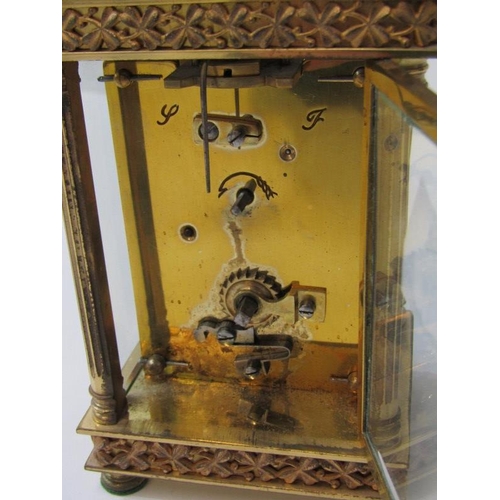 100 - CARRIAGE CLOCK, antique brass bevelled glass carriage clock with shamrock design and fluted column s... 