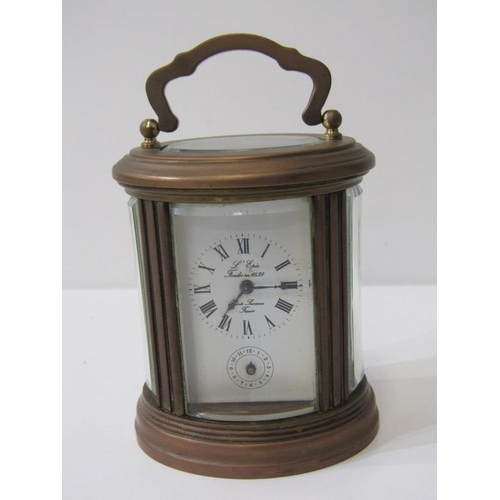 111 - MINIATURE CARRIAGE CLOCK, oval case body with alarm bell base, inscribed 