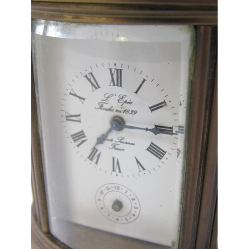 111 - MINIATURE CARRIAGE CLOCK, oval case body with alarm bell base, inscribed 