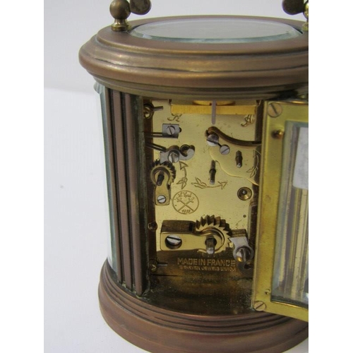 111 - MINIATURE CARRIAGE CLOCK, oval case body with alarm bell base, inscribed 