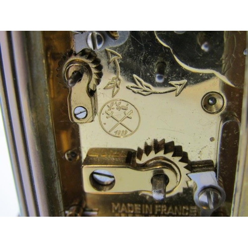 111 - MINIATURE CARRIAGE CLOCK, oval case body with alarm bell base, inscribed 