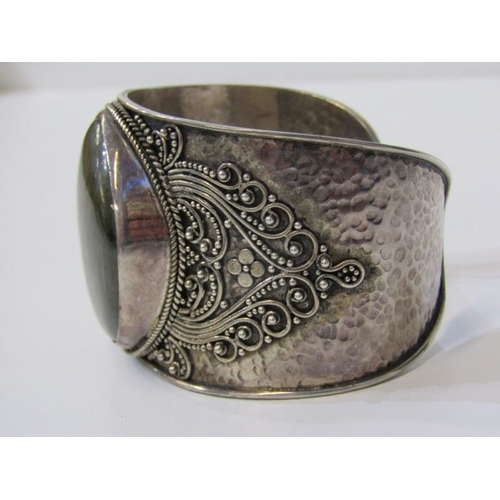 222 - LARGE SILVER STONE SET BANGLE with hammered effect decoration, over 68 grams