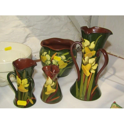 16 - DEVON POTTERY, collection of 4 pieces of daffodil decorated table ware, red serpentine hand cooler, ... 