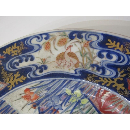 21 - ORIENTAL CERAMICS, a good Arita charger decorated with birds within garden setting, 37cm diameter