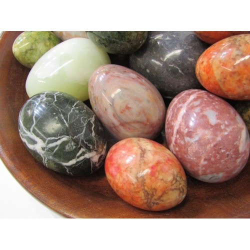 27 - HAND COOLERS, a good collection of coloured stone hand coolers within wooden dish