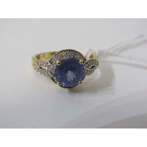 191 - TANZANITE & DIAMOND RING, 18ct yellow gold ring, set a large round tanzanite within a cluster of dia... 