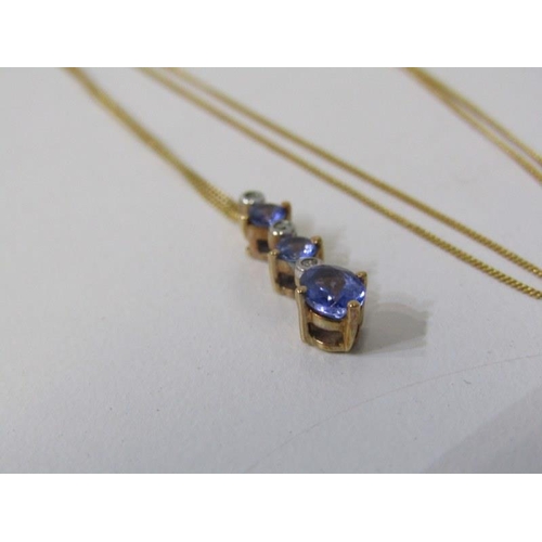 199 - TANZANITE & DIAMOND PENDANT, 9ct yellow gold pendant set graduated tanzanites and diamonds on 18