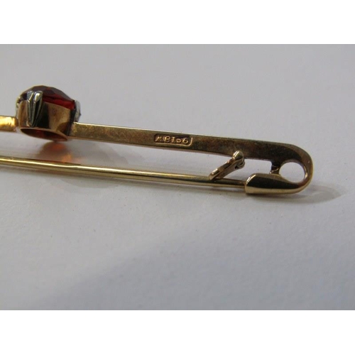 247 - 9ct GOLD BAR BROOCH, set an oval orange stone possibly a hessonite garnet, 2.8 grams