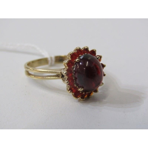 254 - GARNET & FIRE OPAL RING, 9ct yellow gold ring set a cabochon garnet, surrounded by a cluster of fire... 