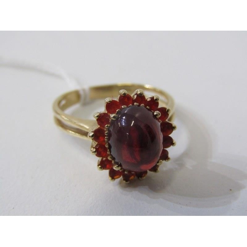 254 - GARNET & FIRE OPAL RING, 9ct yellow gold ring set a cabochon garnet, surrounded by a cluster of fire... 