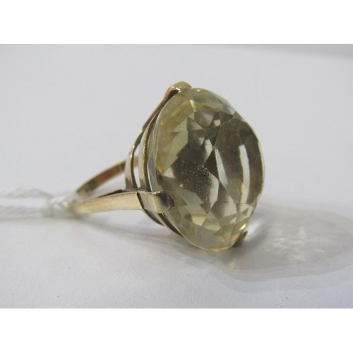 255 - CITRINE RING, retro ring with yellow metal mounts, tests as 9ct, set a large oval citrine, 22mm diam... 