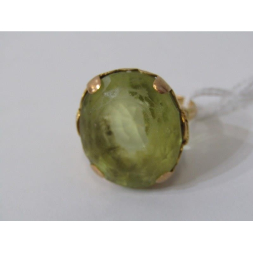 280 - LARGE PERIDOT RING, set in heavy yellow gold (tests as 18ct) set a large oval peridot, 20mm dia, siz... 