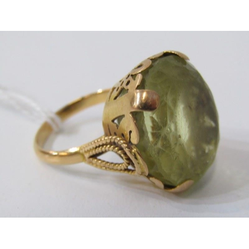 280 - LARGE PERIDOT RING, set in heavy yellow gold (tests as 18ct) set a large oval peridot, 20mm dia, siz... 