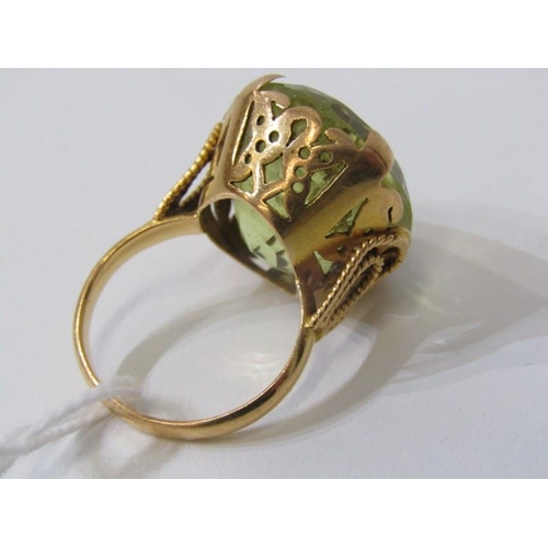 280 - LARGE PERIDOT RING, set in heavy yellow gold (tests as 18ct) set a large oval peridot, 20mm dia, siz... 