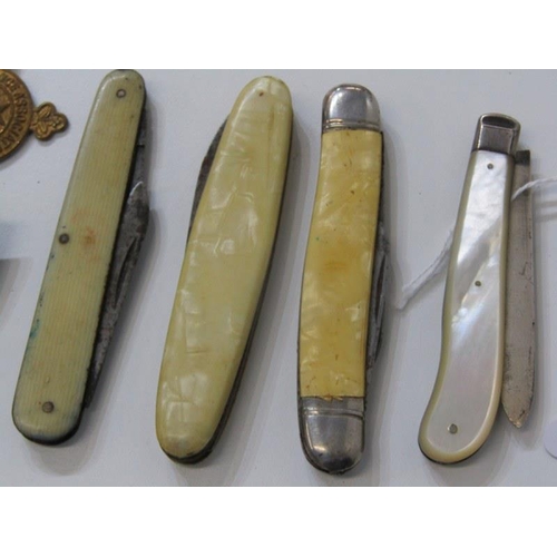 299 - FRUIT KNIVES AND ASSORTED BADGES, mother of pearl decorated fruit knife with silver blade, 3 other a... 