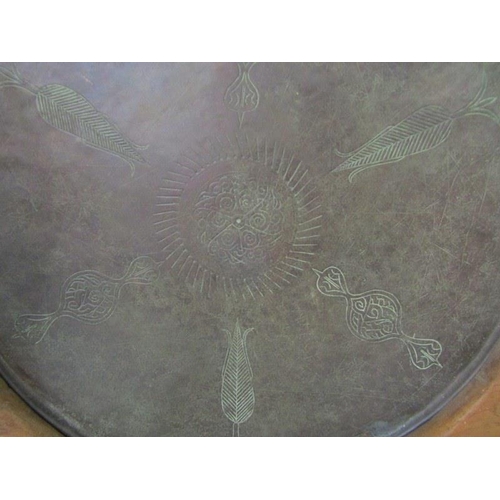 500 - EASTERN METALWARE, large copper circular dish with engraved decoration on stand