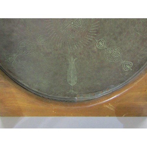 500 - EASTERN METALWARE, large copper circular dish with engraved decoration on stand