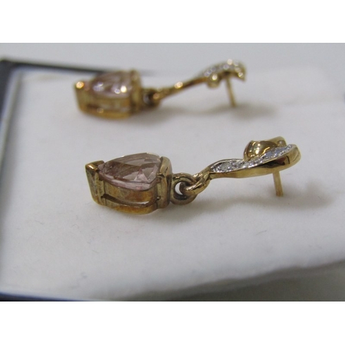 229 - TOPAZ DROP EARRINGS, a pair of 9ct yellow gold earrings set with a triangular form pink topaz, appro... 