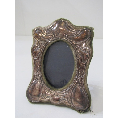 560 - PHOTO FRAMES, a small photo frame with silver mount, together with a brass framed example and an Art... 