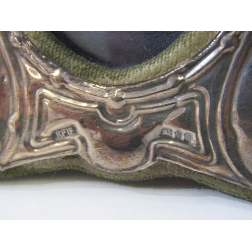 560 - PHOTO FRAMES, a small photo frame with silver mount, together with a brass framed example and an Art... 